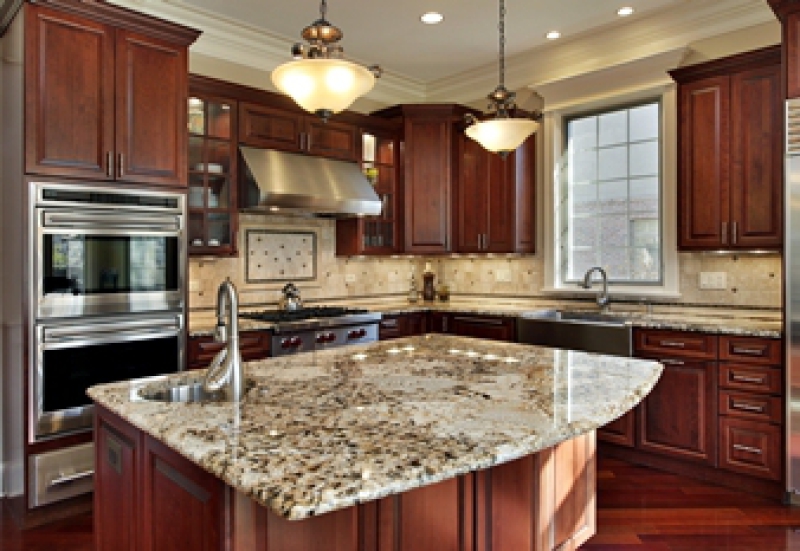 Remodeled kitchen with dark cabinets and granite countertops