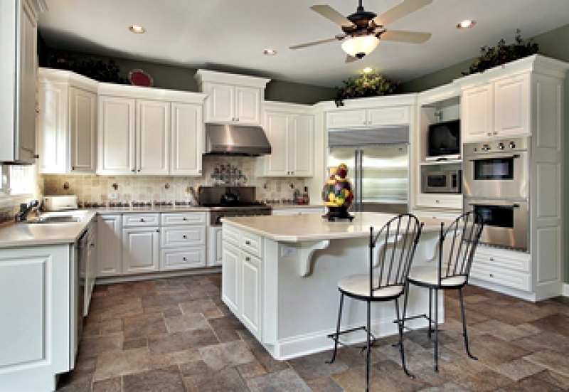 White kitchen with central island and stainless steel appliances