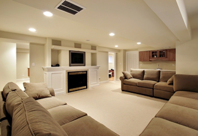Renovated basement with sofas and entertainment center