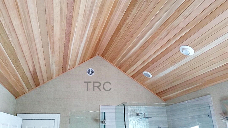 a vaulted bathroom ceiling with cedar planks attached